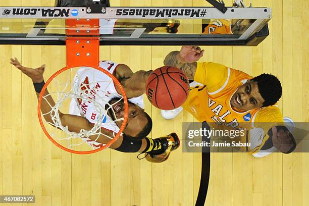 Darien Walker of the Valparaiso Crusaders watches as Dez Wells of the Maryland Terrapins makes a layup during the second round of the 2015 NCAA Men's...