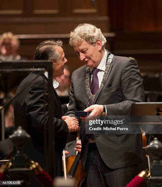 Latvian conductor Mariss Jansonsreceives a gift from Amsterdam Mayor Eberhard van der Laan after his final concert with the Royal Concertgebouw...
