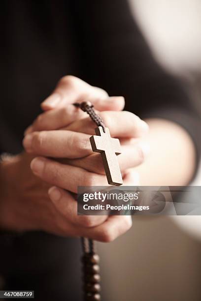 true to his religion - rosary beads stock pictures, royalty-free photos & images