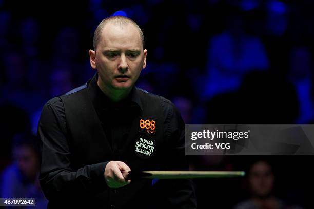Graeme Dott of Scotland reacts against Ronnie O'Sullivan of England during day five of the 2015 Snooker World Grand Prix at Venue Cymru on March 20,...
