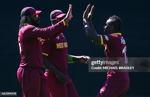 West Indies' Chris Gayle and Andre Russell celebrates the wicket of New Zealand's Kane Williamson during the 2015 Cricket World Cup quarter-final...