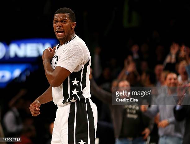 Joe Johnson of the Brooklyn Nets celebrates after teammate Bojan Bogdanovic hit a three pointer in the third overtime against the Milwaukee Bucks at...