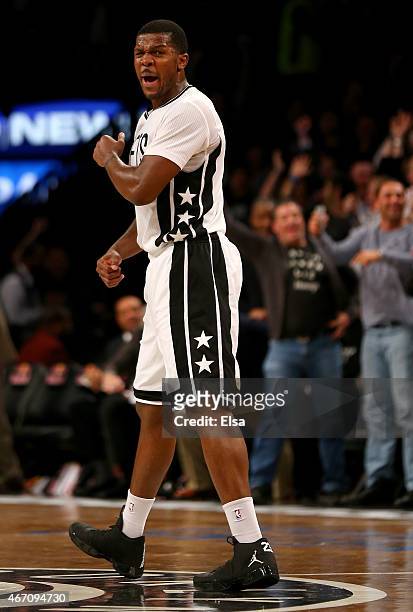 Joe Johnson of the Brooklyn Nets celebrates after teammate Bojan Bogdanovic hit a three pointer in the third overtime against the Milwaukee Bucks at...