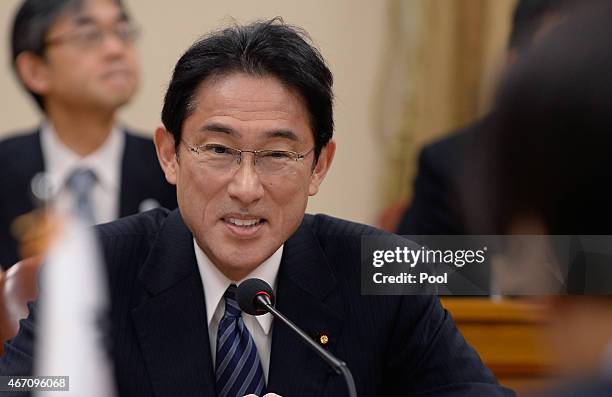 Japanese Foreign Minister Fumio Kishida talks with South Korean Foreign Minister Yun Byung-Se during their meeting at foreign ministry on March 21,...