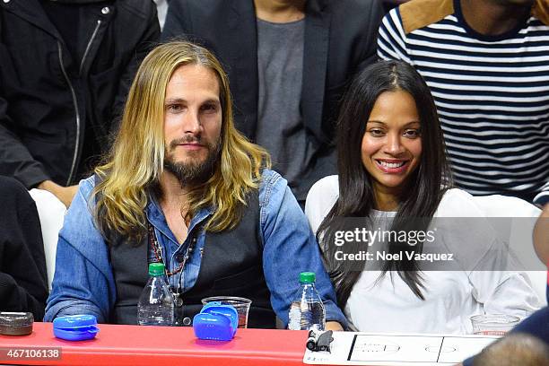 Zoe Saldana and her husband Marco Perego attend a basketball game between Washington Wizards and the Los Angeles Clippers at Staples Center on March...