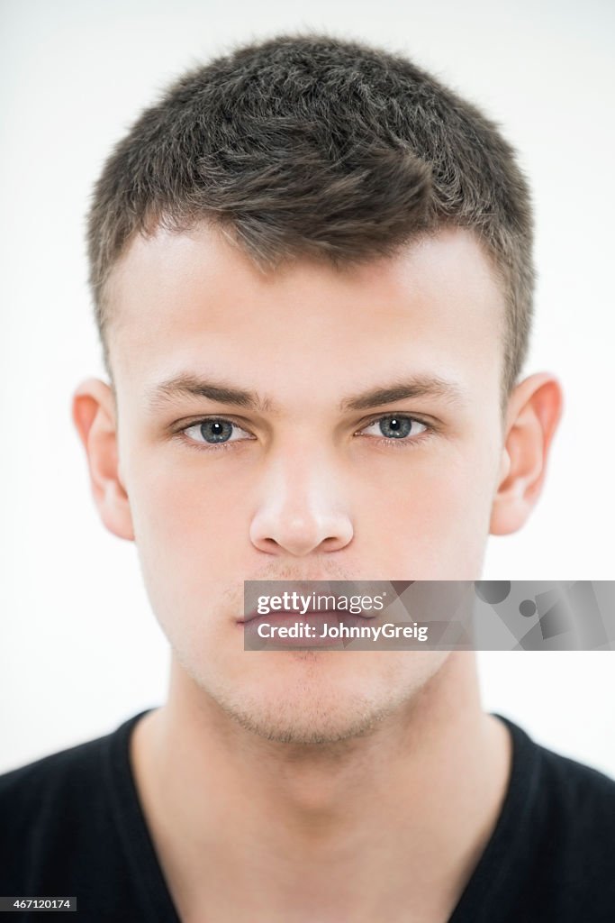 Serious Teenage Boy On White Background