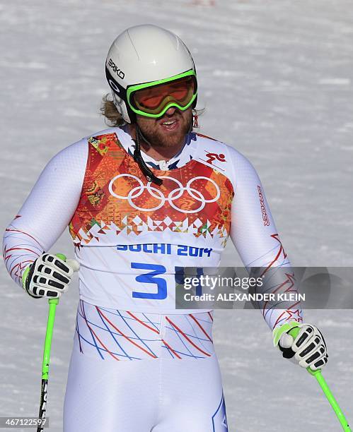 Skier Erik Fisher reacts in the finish area during a Men's Alpine Skiing Downhill training session at the Rosa Khutor Alpine Center on February 6...