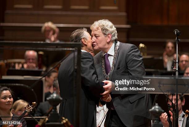 Latvian conductor receives a gift from Amsterdam Mayor Eberhard van der Laan after his final concert with the Royal Concertgebouw Orchestra on March...