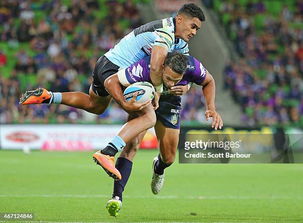 Will Chambers of the Storm is tackled by Ricky Leutele of the Sharks during the round three NRL match between the Melbourne Storm and the Cronulla...