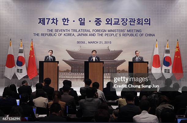 Japanese Foreign Minister Fumio Kishida, South Korean Foreign Minister Yun Byung-Se and Chinese Foreign Minister Wang Yi attend the joint press...