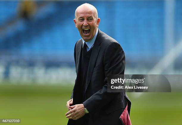 Tony Pulis the manager of West Bromwich Albion shares a joke as he arrives at the Etihad Stadium prior to the Barclays Premier League match between...