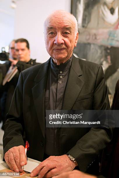 Armin Mueller-Stahl writes autograph cards during the opening of 'Menschenbilder' exhibition preview at Kunsthalle Brennabor on March 21, 2015 in...