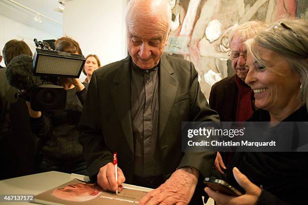 Armin Mueller-Stahl writes autograph cards during the opening of 'Menschenbilder' exhibition preview at Kunsthalle Brennabor on March 21, 2015 in...