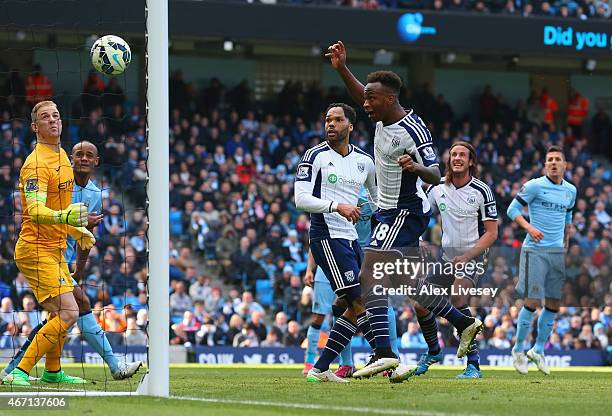 Joe Hart of Manchester City looks on as Saido Berahino of West Brom hits the cross bar during the Barclays Premier League match between Manchester...