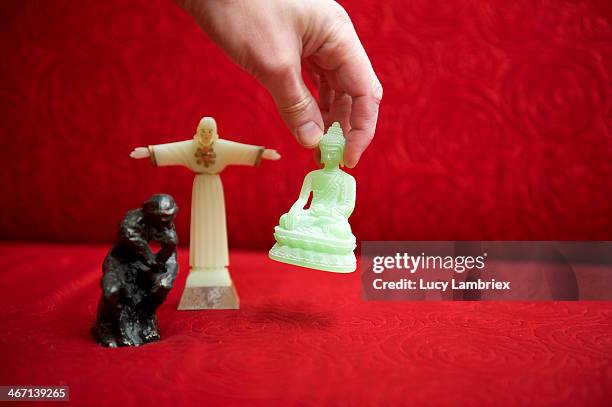 humanism, christianity or buddhism? - red buddha statue stock pictures, royalty-free photos & images