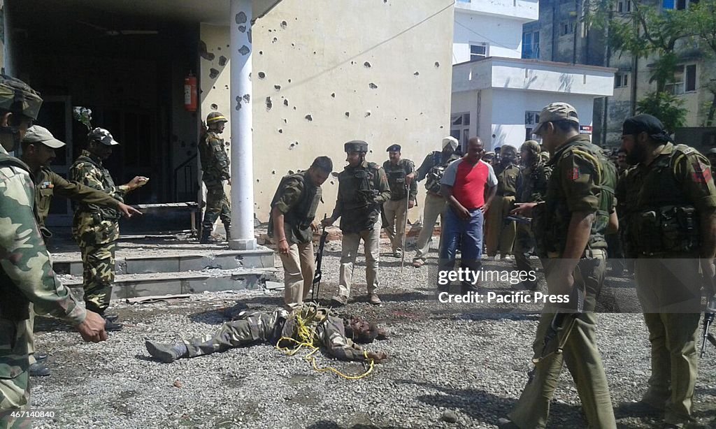 Indian Army and Police officers gather around one of the...