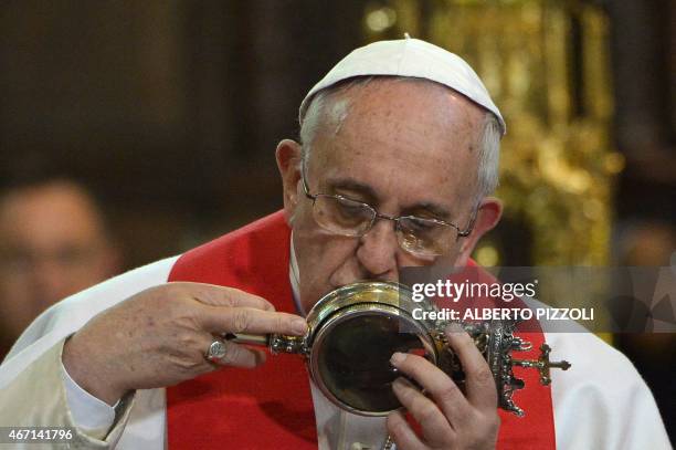 Pope Francis kisses the ampulla containing the blood of San Gennaro at the Duomo as part of his pastoral visit on March 21, 2015 in Naples. Hundreds...