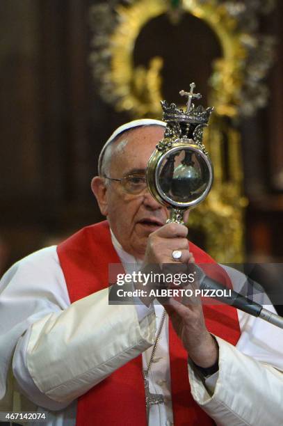 Pope Francis holds the ampulla containing the blood of San Gennaro at the Duomo as part of his pastoral visit on March 21, 2015 in Naples. Hundreds...