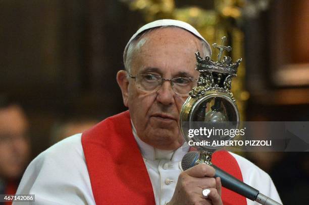 Pope Francis holds the ampulla containing the blood of San Gennaro at the Duomo as part of his pastoral visit on March 21, 2015 in Naples. Hundreds...