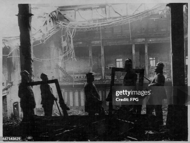 Firemen surveying the ruins following the Reichstag fire, Germany, 1933.