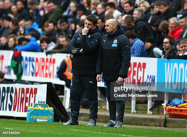 John Carver, manager of Newcastle United and Steve Stone talk during the Barclays Premier League match between Newcastle United and Arsenal at St...