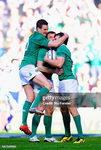 Ireland centre Jared Payne is congratulated by Johnny Sexton and Tommy Bowe during the RBS Six Nations match between Scotland and Ireland at...