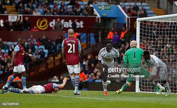 Bafetibis Gomis of Swansea City celebrates scoring the winning goal during the Barclays Premier League match between Aston Villa and Swansea City at...