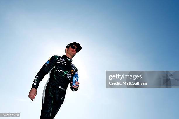 Blake Koch, driver of the AQUAhydrate Toyota, walks on the grid prior to qualifying for the NASCAR XFINITY Series Drive4Clots.com 300 at Auto Club...