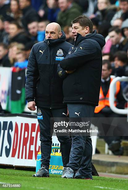 John Carver, manager of Newcastle United and Steve Stone talk during the Barclays Premier League match between Newcastle United and Arsenal at St...