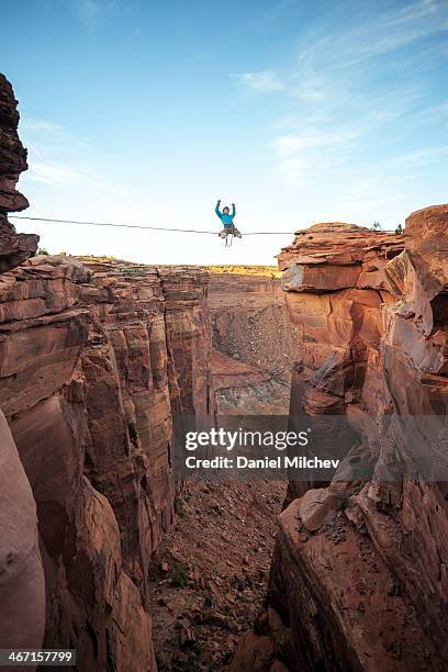 man on a high line over a canyon in moab. - highlining stock pictures, royalty-free photos & images