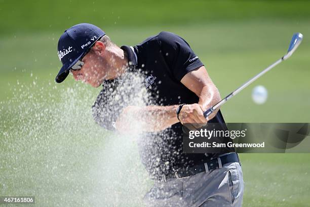 Morgan Hoffmann of the United States hits an approach shot from a bunker on the first hole during the third round of the Arnold Palmer Invitational...