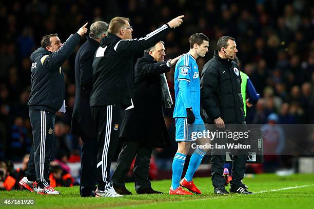 Dick Advocaat, manager of Sunderland speaks with Adam Johnson of Sunderland as he prepares to come on as a substitute during the Barclays Premier...