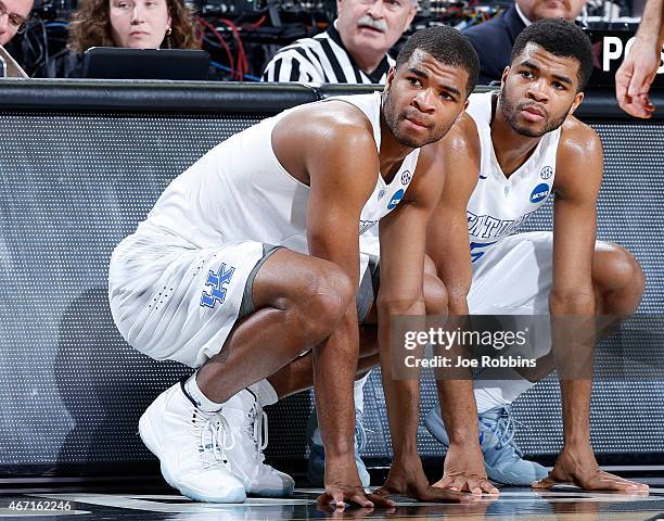 Teammates and brothers, Aaron Harrison and Andrew Harrison of the Kentucky Wildcats, wait to go in the game against the Cincinnati Bearcats during...