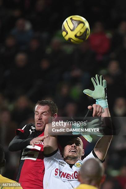 Rennes' French defender Sylvain Armand vies with Nantes' French goalkeeper Remy Riou during the French L1 football match Rennes against Nantes on...