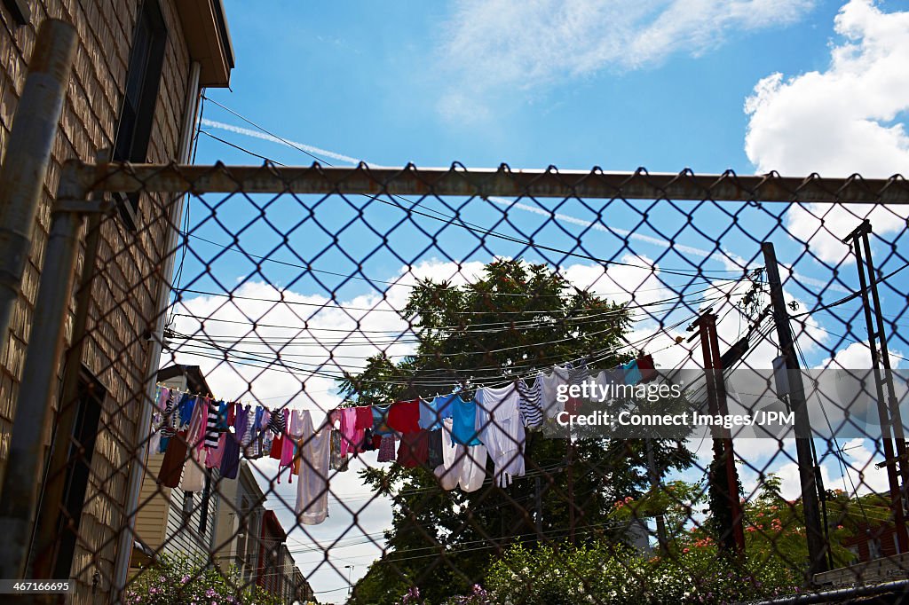 View through wire fence to laundry on clothes line