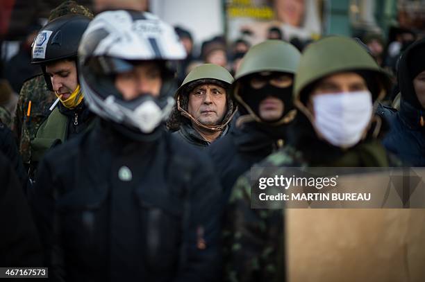 Anti-government protesters demonstrate around the parliament in Kiev on February 6, 2014 to push to the deputies of the majority to change the...