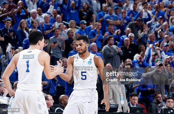Teammates Devin Booker and Andrew Harrison of the Kentucky Wildcats react against the Cincinnati Bearcats during the third round of the 2015 NCAA...