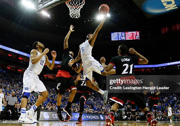 Kentucky's Andrew Harrison drives in for the basket and a foul as the Wildcats defeated Cincinnati, 64-51, in the third round of the NCAA Tournament...