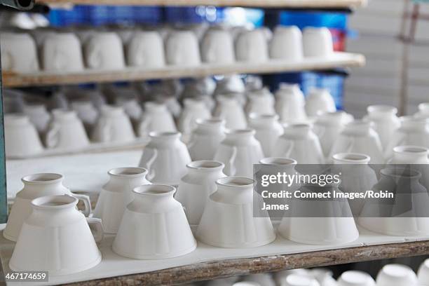 white teacups in pottery factory - ceramic stock pictures, royalty-free photos & images