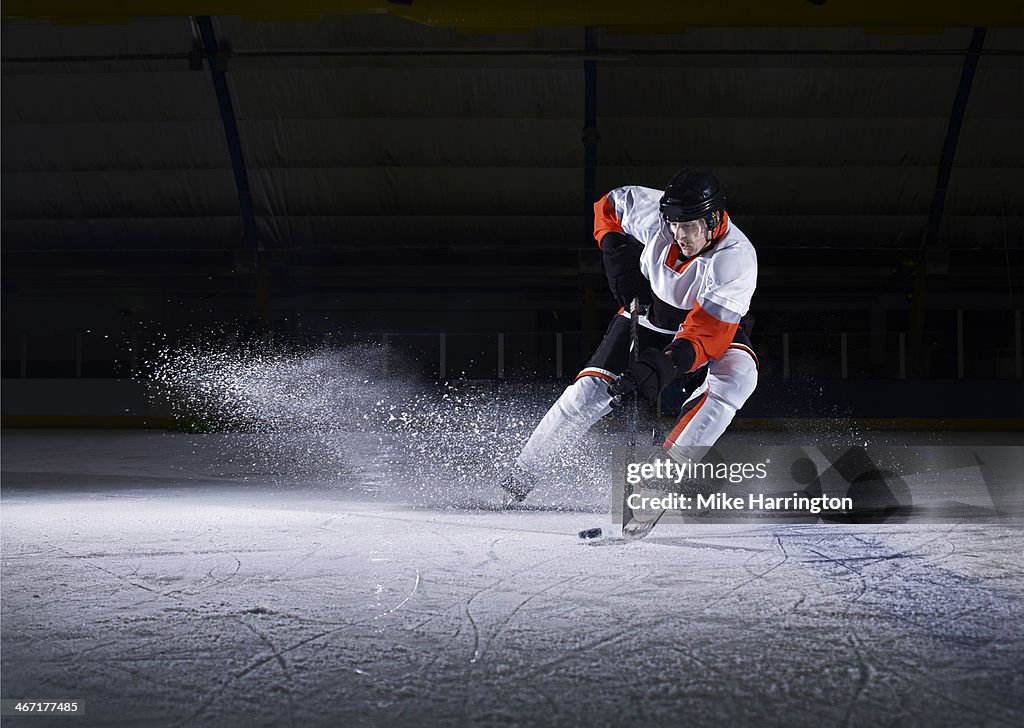 Male Ice Hockey player taking puck