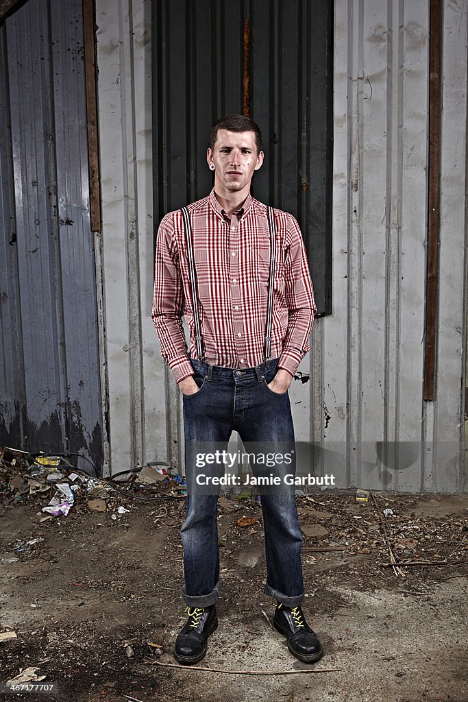 Man with plug ear piercing and red and white shirt