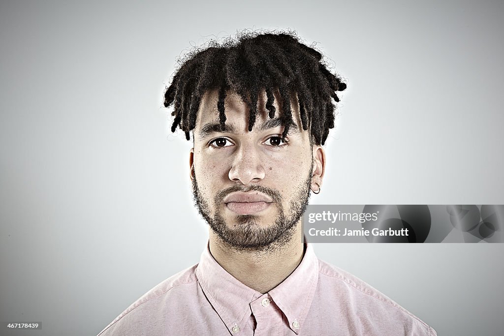 Studio portrait of a young male dressed in a shirt