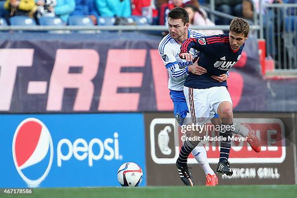 Jack McInerney of Montreal Impact fouls Scott Caldwell of New England Revolution during the second half at Gillette Stadium on March 21, 2015 in...