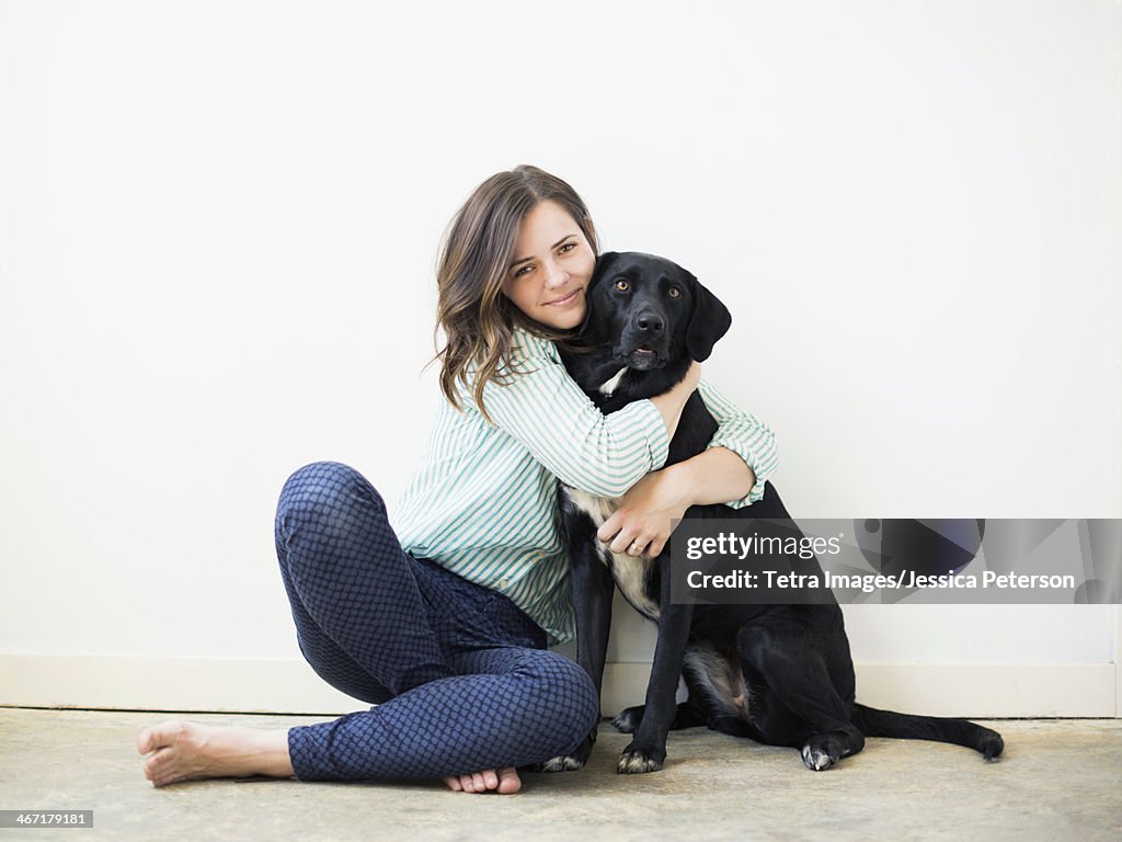 Portrait of woman with black dog