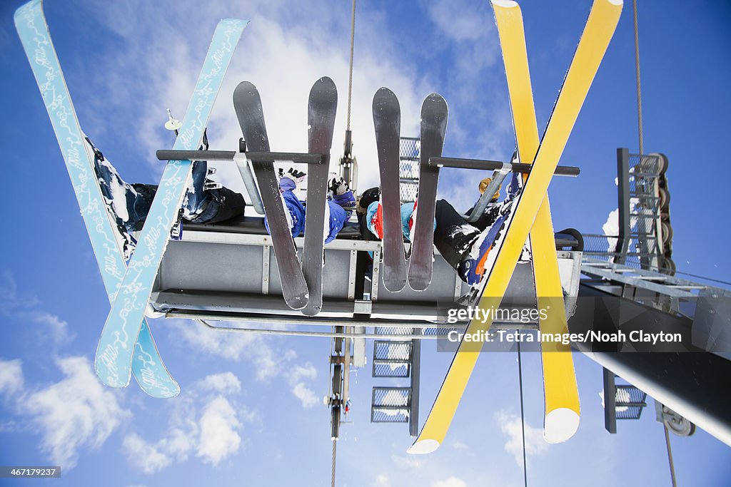 USA, Montana, Whitefish, Family of skiers on ski lift seen from below