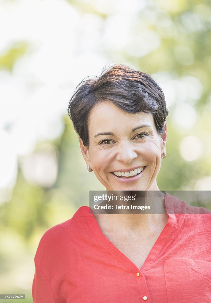 USA, New York State, New York City, Portrait of happy mature woman smiling