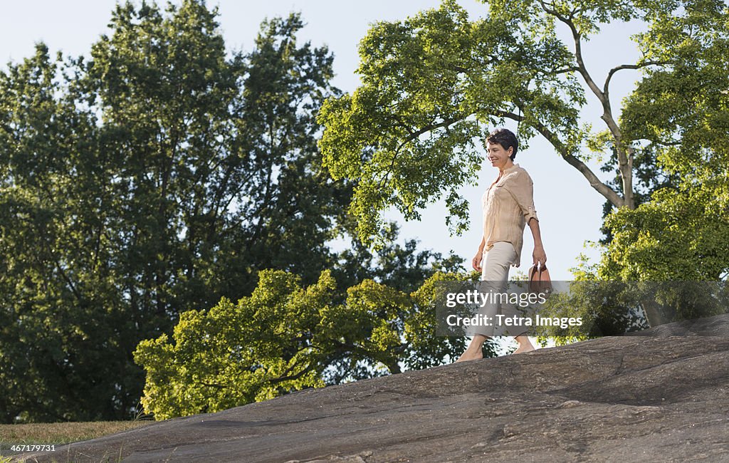 USA, New York State, New York City, Mature woman walking on rock