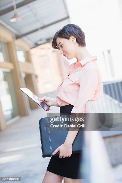 usa, new jersey, jersey city, portrait of business woman using digital tablet - pencil skirt beautiful stock pictures, royalty-free photos & images