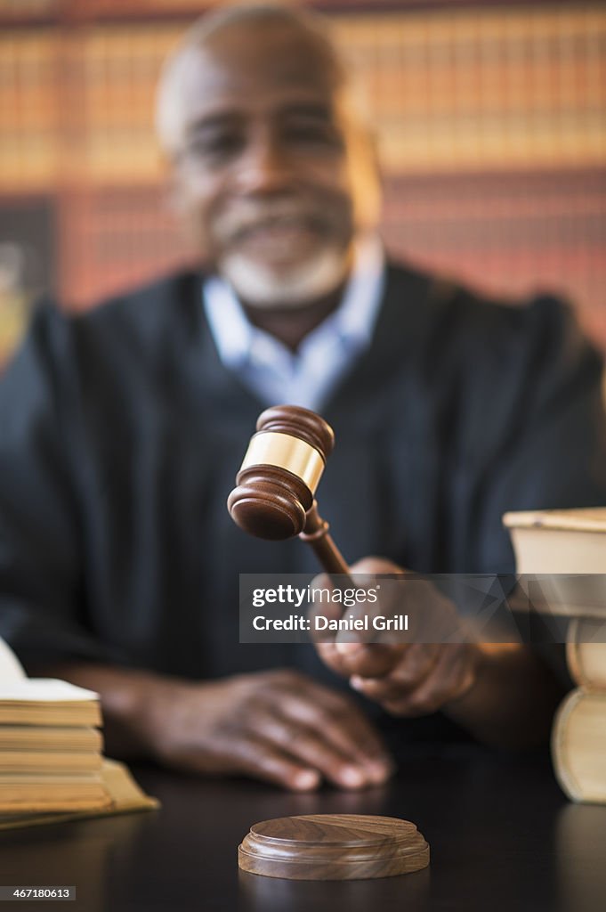 USA, New Jersey, Jersey City, Judge holding gavel in courtroom
