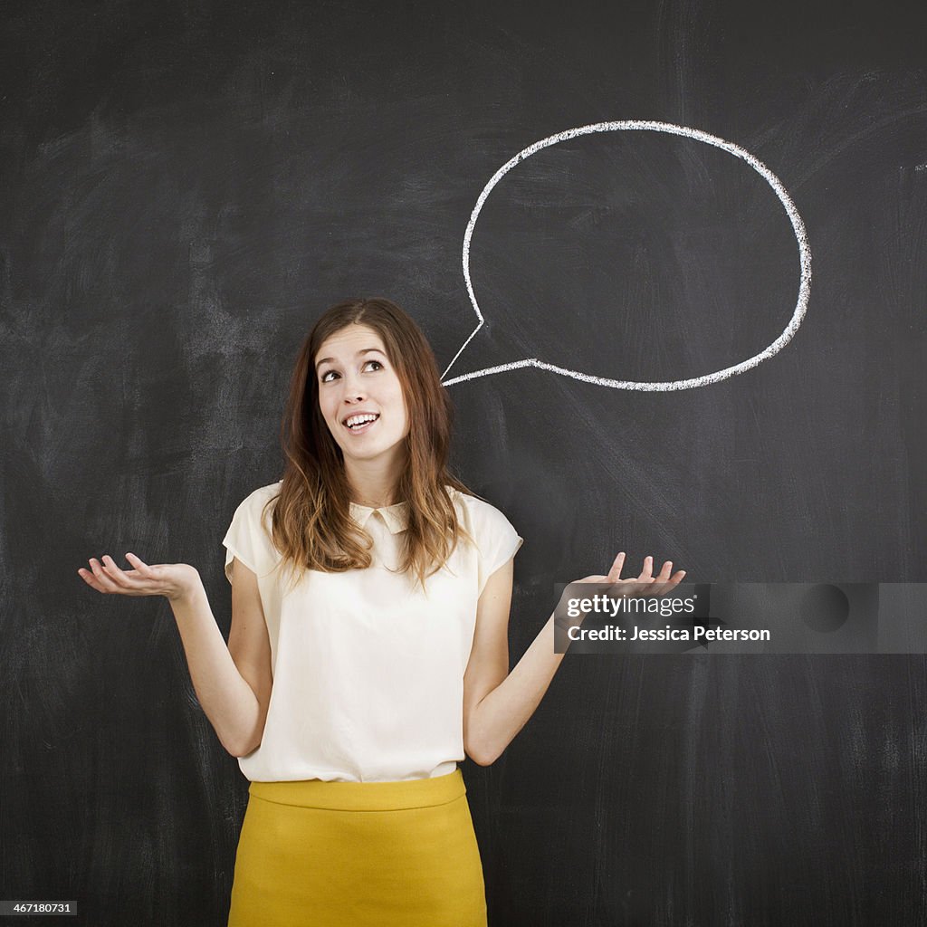 Studio portrait of woman with chalk speech bubble